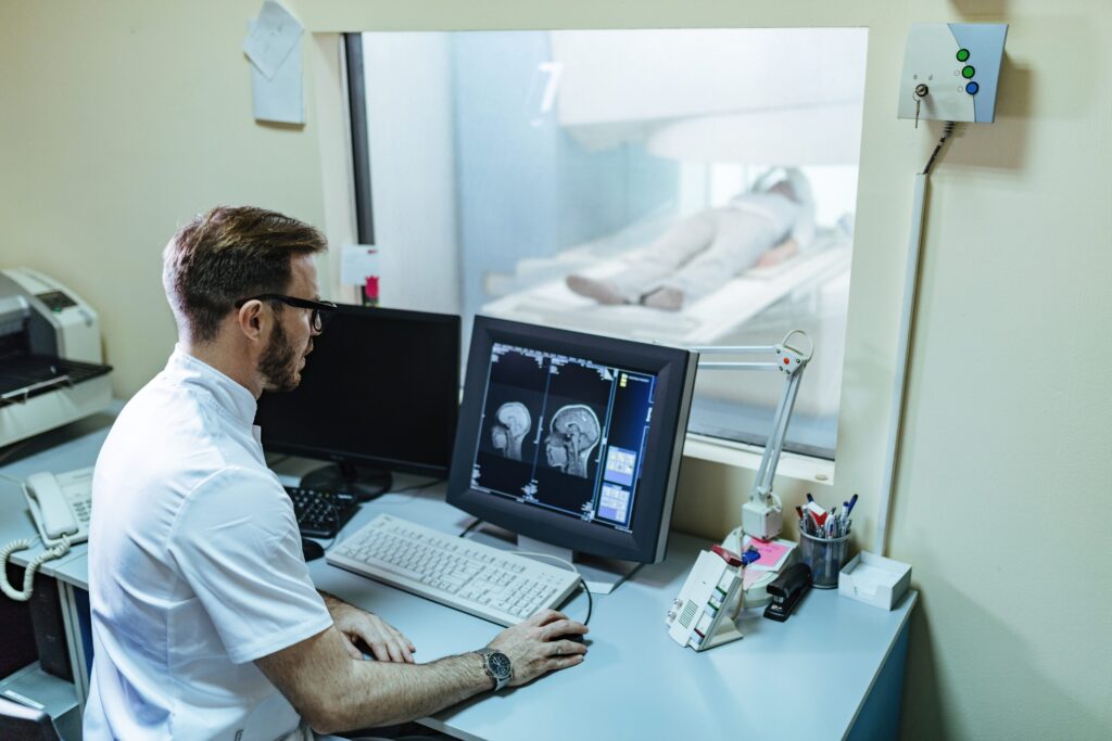 male-radiologist-analyzing-mri-scan-results-patient-computer-monitor-control-room-4-min